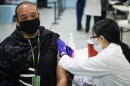 A patient gets vaccinated at an event hosted by Denver Indian Health and Family Services