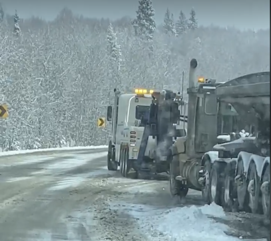 The Black Gold tow truck maneuvers into position in front of one of the ore-hauling trucks.