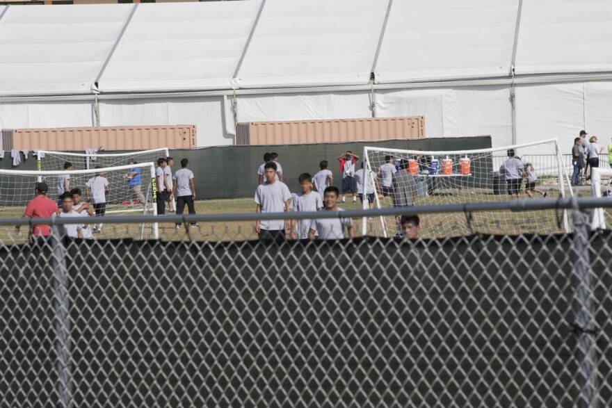 Children play soccer outside of a facility holding unaccompanied and separated children in Homestead.