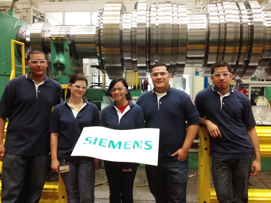 Rebeca Espinal (center) and other apprentices work on Siemens' factory floor in Charlotte, N.C.