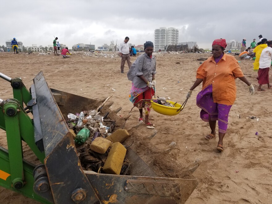 At Mumbai's Versova Beach, dozens of volunteers show up several times a week to rake up trash.