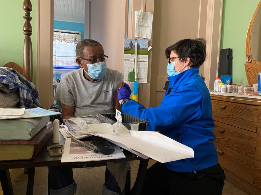 Cabarrus paramedic Ann Coffey administers a first dose of the Pfizer COVID-19 vaccine to 79-year-old Concord resident Henry Crowder.