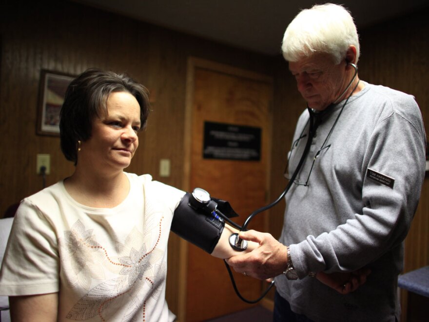 Physician assistant Tom Harward takes a patient's blood pressure in an exam room at the Belington Clinic, a community health center in Belington, W.Va. Across the U.S., state officials like the amount of increased federal spending in the new health care law, but they are wary of how high their own costs will be and how much heavier their workload is about to become.