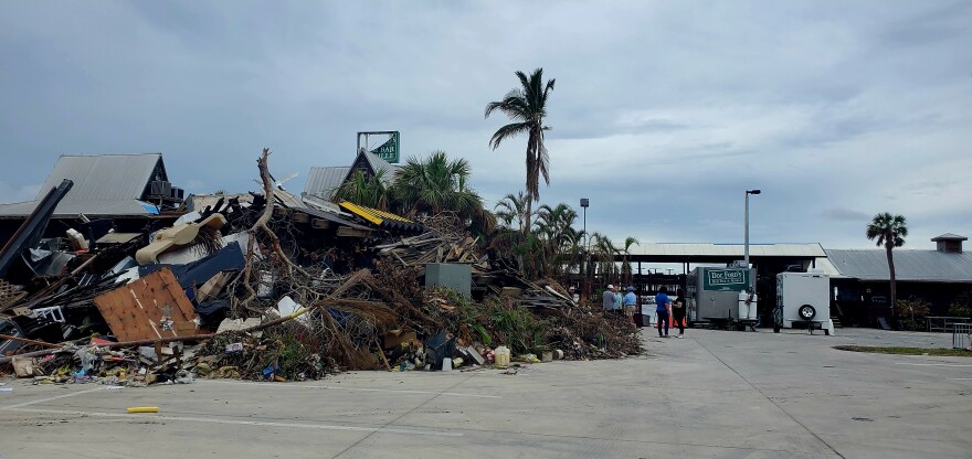 Damage is shown outside Doc Ford's restaurant on Fort Myers Beach.