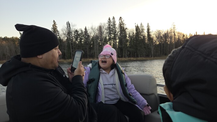 Endazhi-Nitaawiging families celebrate the arrival of the school's new pontoon on Nov. 12, 2025, on Fuller's Lake on the Red Lake Nation.