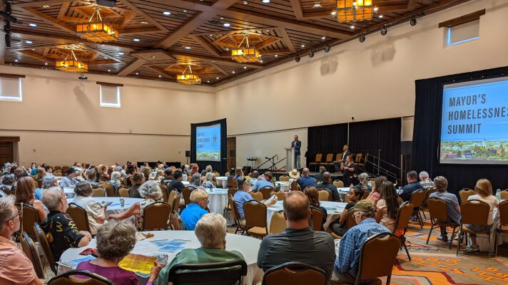 Attendees listen to Mayor Michael Garcia speak at the Santa Fe Mayor's Homelessness Summit.