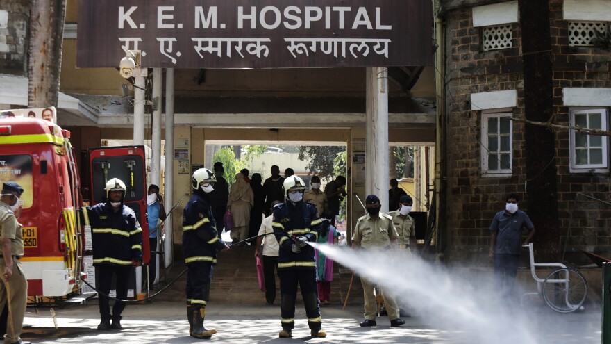 Fire brigade personnel sanitize a government hospital as part of precautionary measures against the coronavirus in Mumbai, India, on Tuesday.