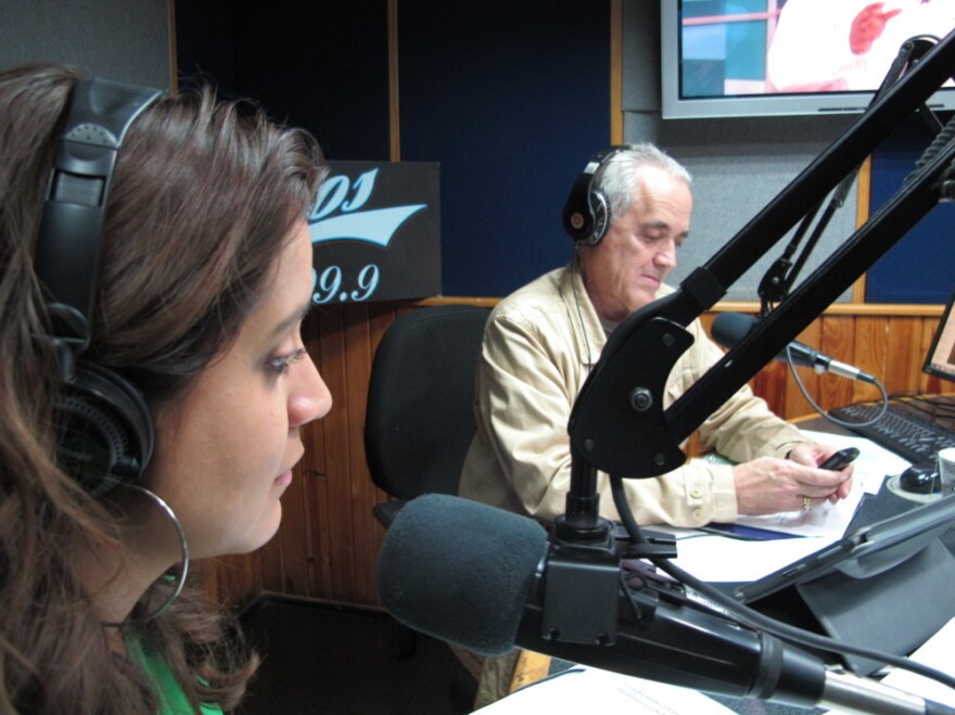 Venezuelan radio host Nelson Bocaranda (right) anchors his evening talk show, <em>The Happy Traffic Jam</em>, with co-host Mariela Celis in Caracas during a recent March broadcast.