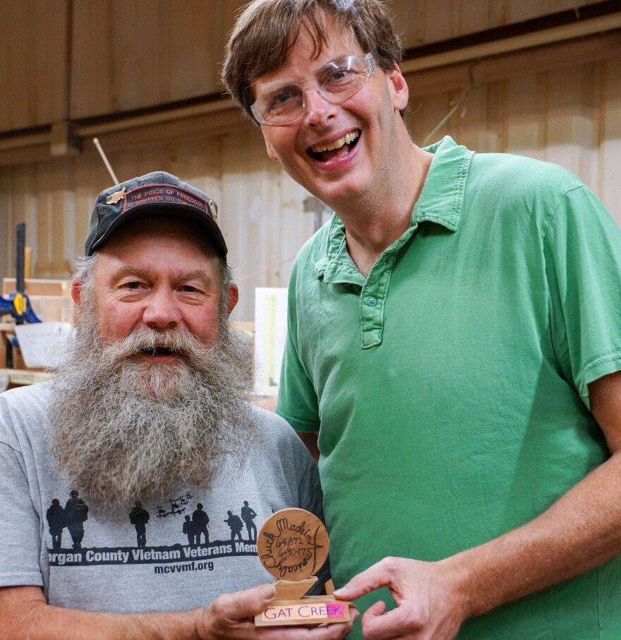 Chuck Hampe and Gat Caperton celebrate Hampe's accomplishments on his final day of work.