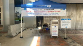 A blue pop-up tent from the Miami-Dade Elections Department showing where voters can leave their ballots