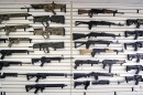 FILE - In this photo taken Oct. 2, 2018, semi-automatic rifles fill a wall at a gun shop in Lynnwood, Wash. A dozen county sheriffs in Washington state are refusing to enforce restrictions on semi-automatic rifles that voters approved in November. They say the new law might be unconstitutional, and they're waiting for the courts to weigh in. (AP Photo/Elaine Thompson, File)
