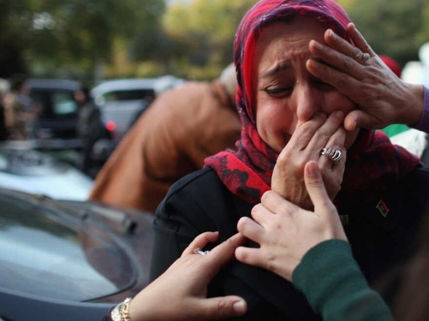 <p> A woman is overcome with emotion during celebrations outside the Libyan Embassy in London on Thursday, after the news that former Libyan leader Col. Moammar Gadhafi was killed after an assault on his hometown of Sirte.</p>