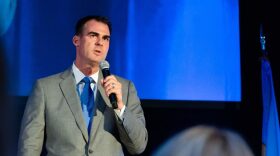 Kevin Stitt is shown speaking at a forum in Oklahoma City in August during the campaign.