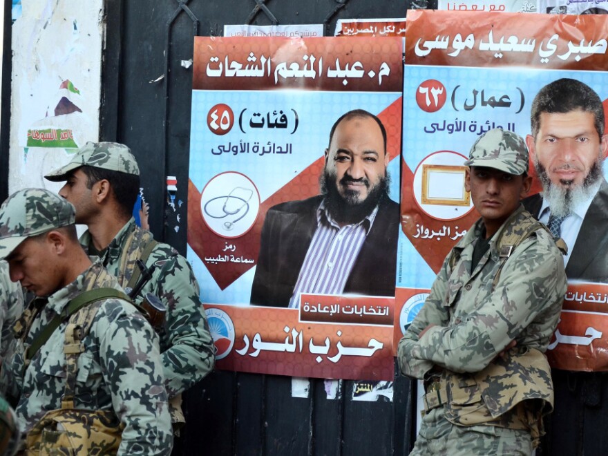 Egyptian soldiers stand in front of campaign posters for candidates from the hard-line Islamist Salafist Al-Nour party, in the coastal city of Alexandria.