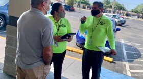 Oswaldo Simon, left, said he appreciated the help state canvassers provided signing him up for a COVID-19 vaccine appointment in his neighborhood.