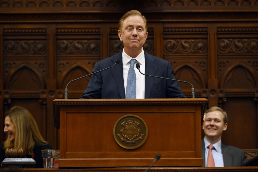 FILE - Connecticut Gov. Ned Lamont delivers the State of the State address during the opening session of the Legislature at the State Capitol, Jan. 4, 2023, in Hartford, Conn. Gov. Lamont announced Monday, Feb. 6, 2023 his new two-year budget plan will include the state's first personal income tax rate reduction since 1996, one of several tax relief proposals he will officially unveil to the General Assembly on Wednesday. (AP Photo/Jessica Hill, file)