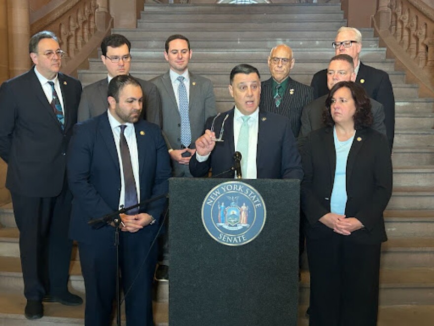 Sen. Anthony Palumbo, center, announces a complaint against Chief Judge Rowan Wilson on March 11, 2026.