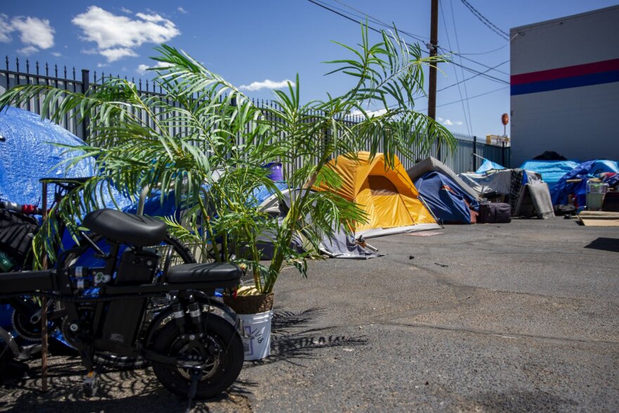 The encampment located in the parking lot of Quirky Used Books in Albuquerque is pictured on April 25, 2025.