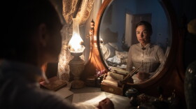 Women looks in mirror