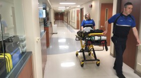 Paramedics wheel a gurney through an emergency department in Knoxville. Roughly 200,000 Tennesseans now buy coverage from the individual markeplace under the Affordable Care Act.