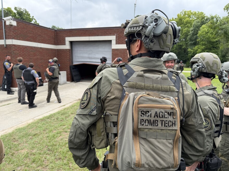 In this photo provided by the North Carolina State Bureau of Investigation, law enforcement officers wait outside the Bertie-Martin Regional Detention Center on Monday, June 29, 2026, in Windsor, N.C.