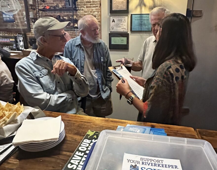 Pamlico-Tar Riverkeeper Katey Zimmerman talks to Blounts Creek supporters at a recent postcard-signing party.