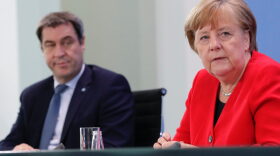 Markus Soeder, Bavaria's State Premier and German Chancellor Angela Merkel (R) attend a press conference at the Chancellery in Berlin on May 6, 2020 after holding a video conference with the leaders of the Federal states on easing the lockdown restrictions during the novel coronavirus COVID-19 pandemic. 