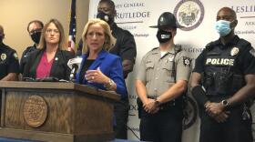  Arkansas Attorney General Leslie Rutledge (center) speaks to reporters alongside law enforcement officials and Arkansas Public Safety Secretary Jami Cook (left).