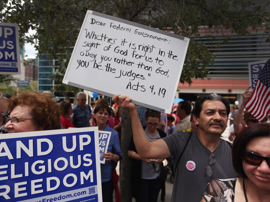 Protesters hold signs as they attend the 'Stand Up for Religious Freedom Rally', in front of the United States Courthouse on June 8, in Miami, Fla. Organizers voiced their opposition to Health and Human Services Mandate, which requires all employer-offered health insurance to cover contraceptives.