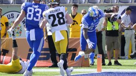 Kentucky running back Chris Rodriguez Jr. (24), right, scores on a 5-yard touchdown pass play as tight end Justin Rigg (83) and Iowa defensive back Jack Koerner (28) watch during the first half of the Citrus Bowl NCAA college football game, Saturday, Jan. 1, 2022, in Orlando, Fla. (AP Photo/Phelan M. Ebenhack)