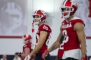 Indiana wide receivers Charlie Becker (left) and Nick Marsh walk the field during the first day of spring football practice Thursday.