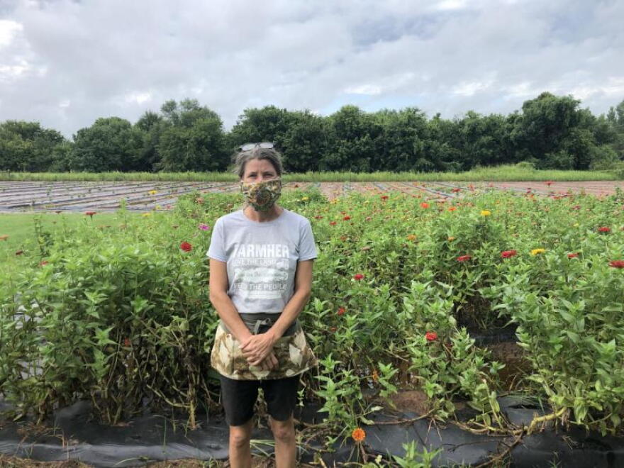 Katie Plohocky, executive director of the Healthy Community Store Initiative, stands in front of fields on Joe's Farm in Bixby, Oklahoma  on July 30. Plohocky helped salvage leftover crops on the farm last year when the nearby creek flooded. 