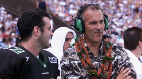 FILE - Hawaii coach June Jones and quarterback Nick Rolovich laugh during the fourth quarter action at Aloha Stadium in Honolulu on Dec. 8, 2001.