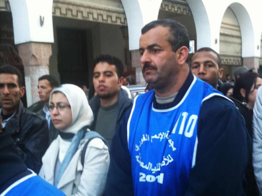 Activists gather to march against youth unemployment in the Moroccan capital of Rabat. Protesters wear colored vests with the slogan of their respective groups.