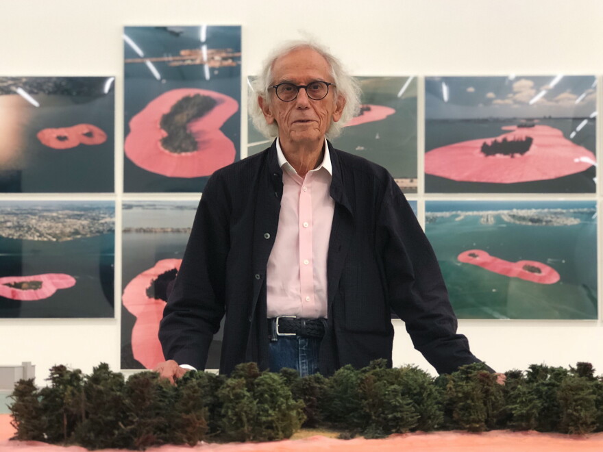 Bulgarian artist Christo stands in front of the exhibition honoring his artistic project "Surrounded Islands" at the Perez Art Museum.