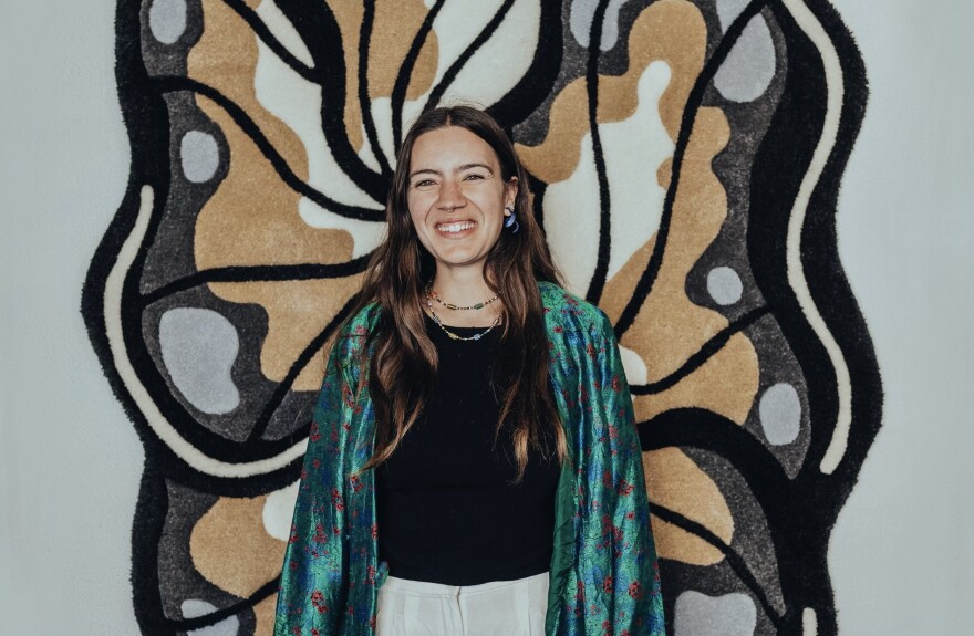 Julia Andreas pictured with one of her handmade tufted rugs.