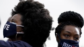 Women listen during a drive-in rally for Democratic presidential candidate former Vice President Joe Biden at Cellairis Amphitheatre in Atlanta, Tuesday, Oct. 27, 2020.