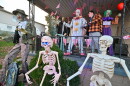 Will Kapmeyer, 15, adjusts one of the clowns on his front porch in Throop. His display will be open for visitors on Halloween.