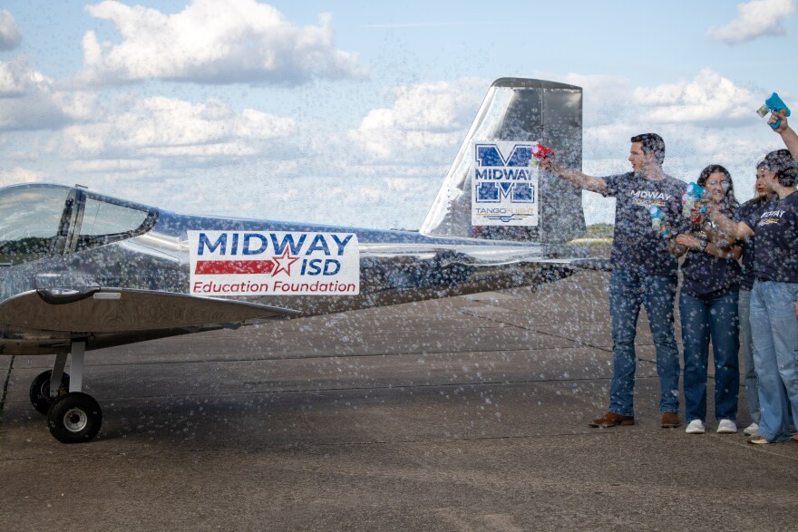 Students in the Tango Flight program perform a ceremonial water canon, using bubbles instead of fire engines, during the "First Flight Celebration" on Wednesday, May 20, 2026.