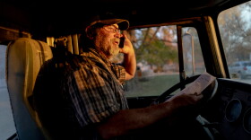 Wes Shoemeyer, a former democratic state senator, talks to his son after transporting thousands of pounds of corn grain to a local ethanol plant on Monday, Oct. 24, 2022, in rural northeast Missouri.
