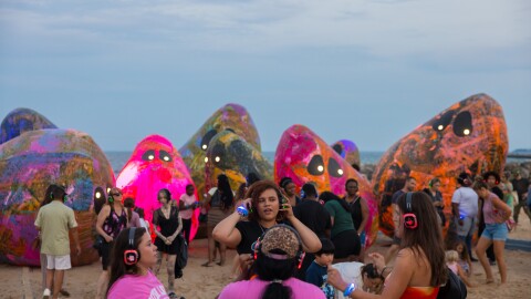 Beachgoers enjoy a silent rave next to the Archaea installation at McKinley Beach in Milwaukee, Wis.