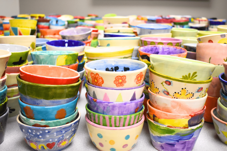 Colorful bowls are stacked in preparation for the "Empty Bowls" event.