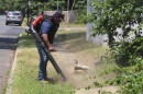 Antonio Espinoza, a supervisor with the Gras Lawn landscaping company, uses a gasoline-powered leaf blower to clean up around a housing development in Brick, N.J. on June 18, 2024.