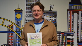 Cartoonist Paul Noth holds a copy of his debut cartoon collection "I Am Going to Eat You… And Other Awkward Truths."