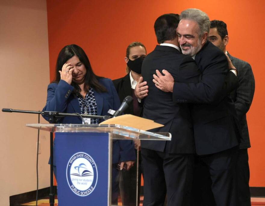 Miami-Dade County Public Schools Superintendent Alberto Carvalho embraces members of his staff prior to announcing his departure for Los Angeles during a press conference at iPrep Academy in Miami on Thursday, Dec. 9.