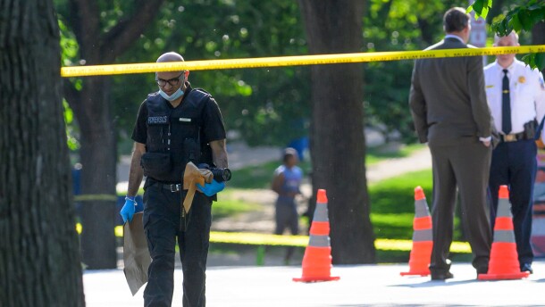A member of the forensics team walks near the scene after a person was shot by law enforcement near the Washington Monument in Washington, Monday, May 4,, 2026. (AP Photo/Rod Lamkey Jr.)