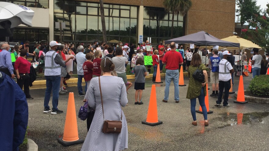 Members of the Duval Schools Pandemic Solutions Team rally for a mask mandate ahead of Tuesday night's Duval County Public Schools Board meeting.