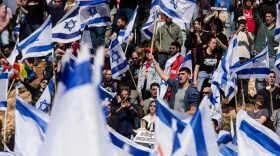 Protestors wave flags as thousands of Israelis attend a rally against Israeli Government's judicial overhaul plan in Jerusalem, Israel.