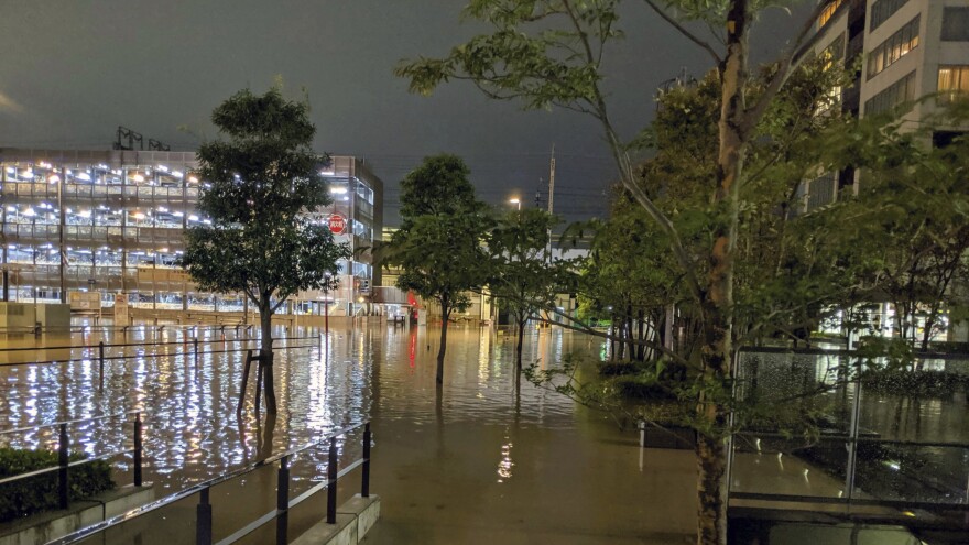 The streets in Kawasaki, near Tokyo, flooded after Typhoon Hagibis made landfall Saturday. Helicopters plucked people from their flooded homes on Sunday as rescue efforts went into full force in wide areas of Japan.