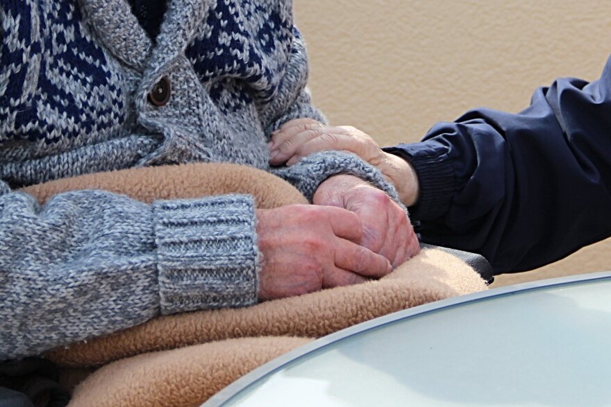 person in wheelchair being consoled